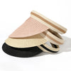 Stack of woven straw sun hats in beige, pink, and black stripes.