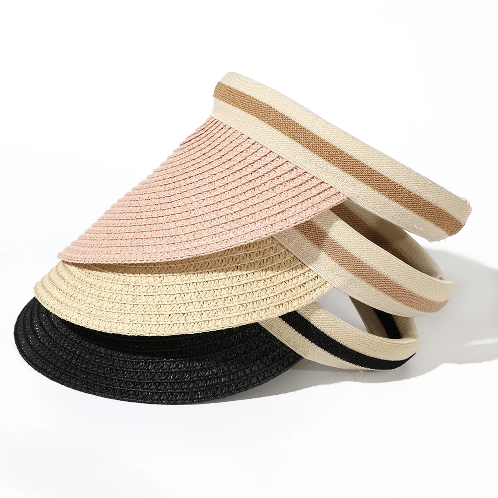 Stack of woven straw sun hats in beige, pink, and black stripes.