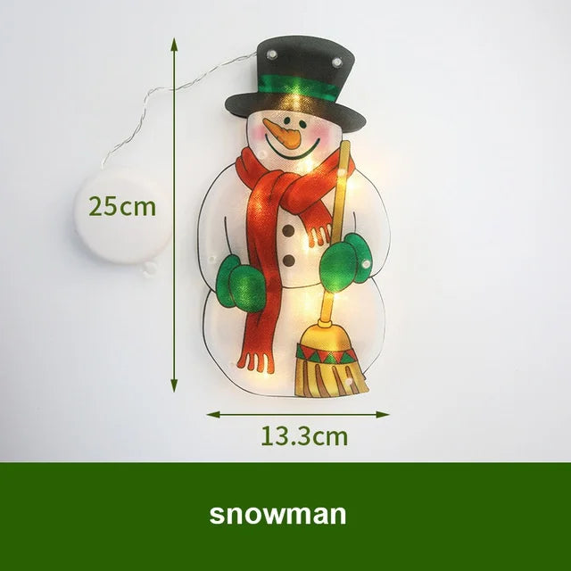 A glowing snowman decoration light featuring a black top hat, orange scarf, and green accents.