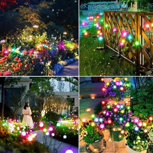 A close-up of a garden illuminated by numerous glowing firefly lights and colorful flowers.
