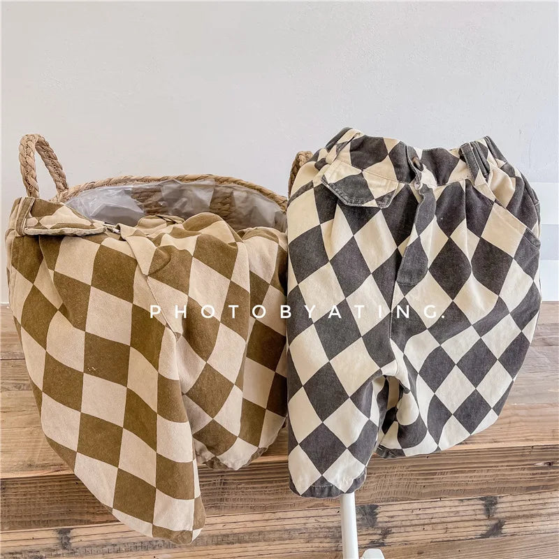 Pair of kids' washed cotton harem pants in a brown and beige checkered pattern displayed on a hanger.