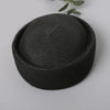 A black woven straw pillbox sun hat with a wide brim shown against a light gray background.