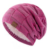 A pink knit beanie with a multicolor pattern and a white sherpa lining.