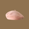 A soft pink classic wool beret hat for women viewed from above.