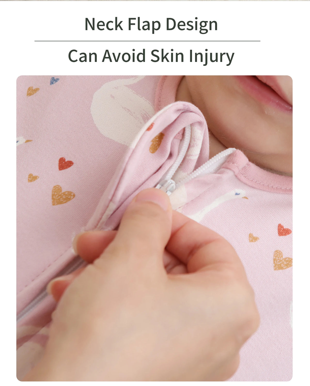 A hand is shown opening the neck flap design of a pink cotton baby sleeping sack with a two-way zipper.