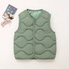 A solid green quilted vest for a child, displayed next to a small stuffed animal.
