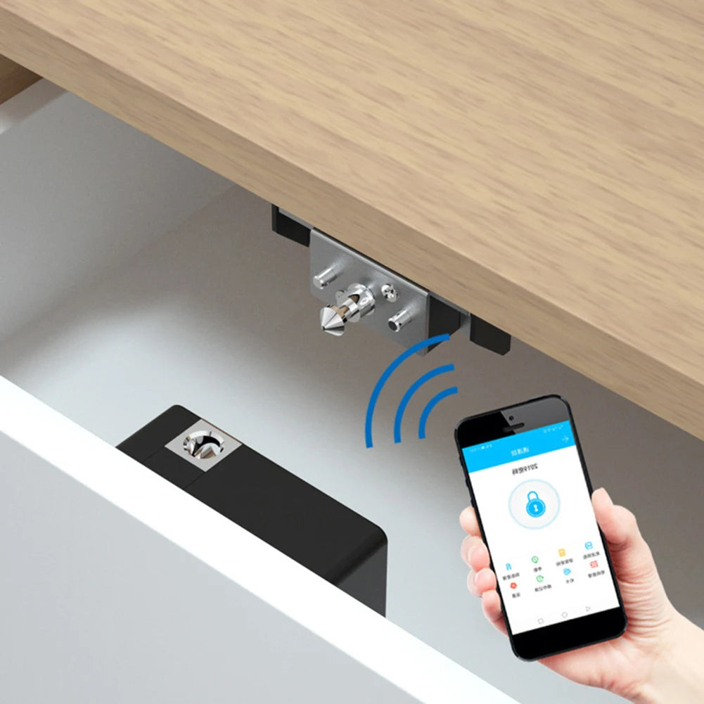 A hand holds a smartphone demonstrating the keyless IC card smart drawer lock mechanism on a wooden cabinet.