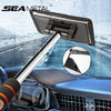 A silver telescopic windshield cleaning brush with a soft absorbent head is shown in a car interior context.