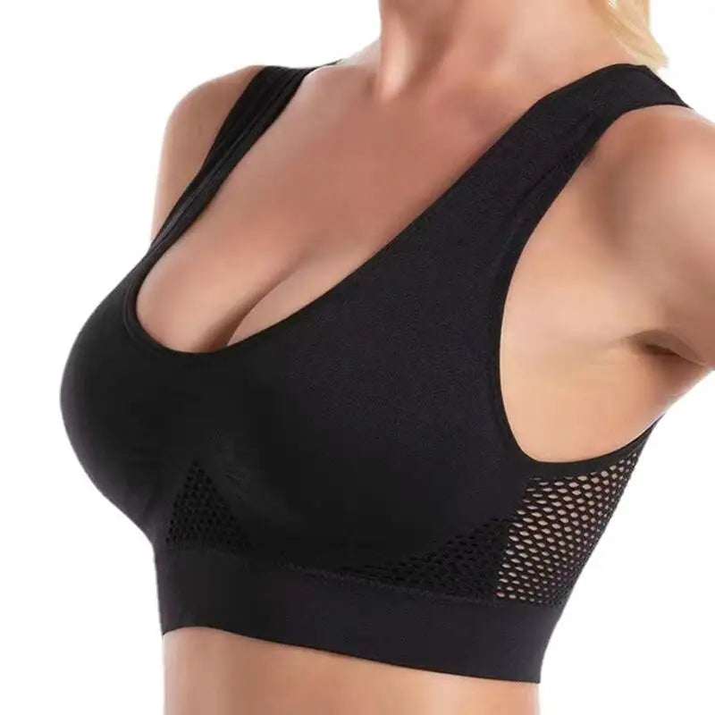 Black breathable plus size sports bra with mesh paneling shown on a model's upper body.