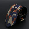 Primer plano de una corbata de hombre slim fit con estampado camuflado en verde oliva y marrón.