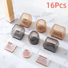 A collection of 16 silicone furniture leg pads in various shapes and shades resting on a white marble surface.