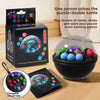 A black box of a 3D rotating puzzle ball is shown next to a bowl of the balls and a hanging school bag.