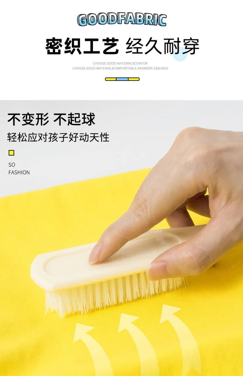 A hand is using a light-colored brush on a yellow fabric, demonstrating the durability of a product.