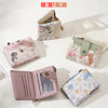 A pink floral print women's buckle coin purse shown in various angles.