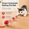Un gato atigrado juega con una bola rodante automática sobre una superficie de madera.