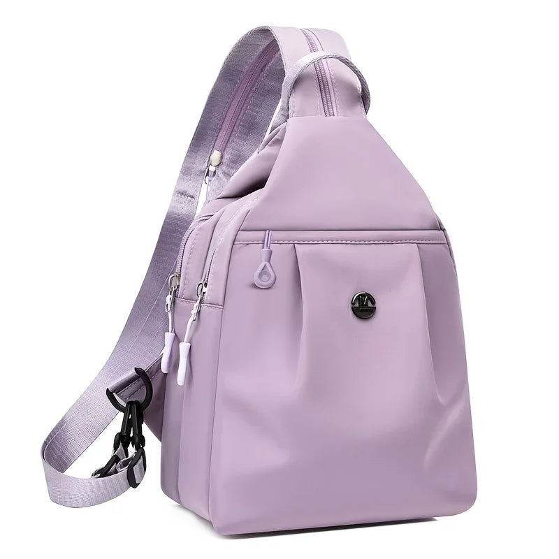 A light purple mini backpack with a zipper and strap is shown from the back.