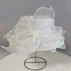 White wide brim organza sun hat with ruffled mesh detail displayed on a stand.
