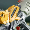 Close-up of a gray and yellow dinosaur-themed water toy gun with a red trigger, set against a green background.