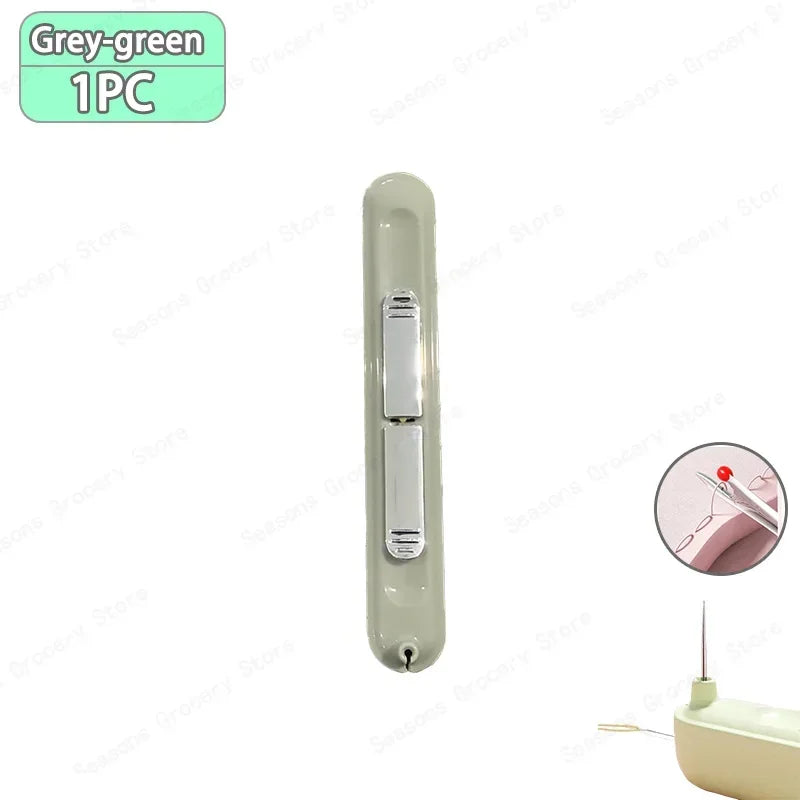 A single grey-green needle threader and seam ripper tool.