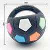 A black squeaky dog ball toy with various colored, soft rubber segments for chewing and fetch.