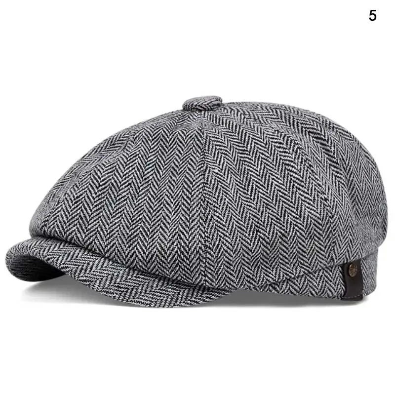 A grey and black patterned newsboy cap is shown from the side.
