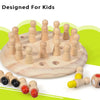A wooden memory match game featuring small wooden figures arranged in a circle on a light wood base.