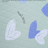Light green fabric with purple watercolor designs and text about Terylene fabric.