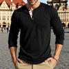 A man wearing a black long-sleeve casual shirt with a chest pocket and khaki pants outdoors.