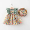 A baby girl's floral print dress with ruffled sleeves and a matching wide-brim hat displayed on a hanger.
