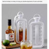 A clear plastic ice cube tray mold is shown next to a bottle of whiskey and a lime, illustrating a cool summer style life con