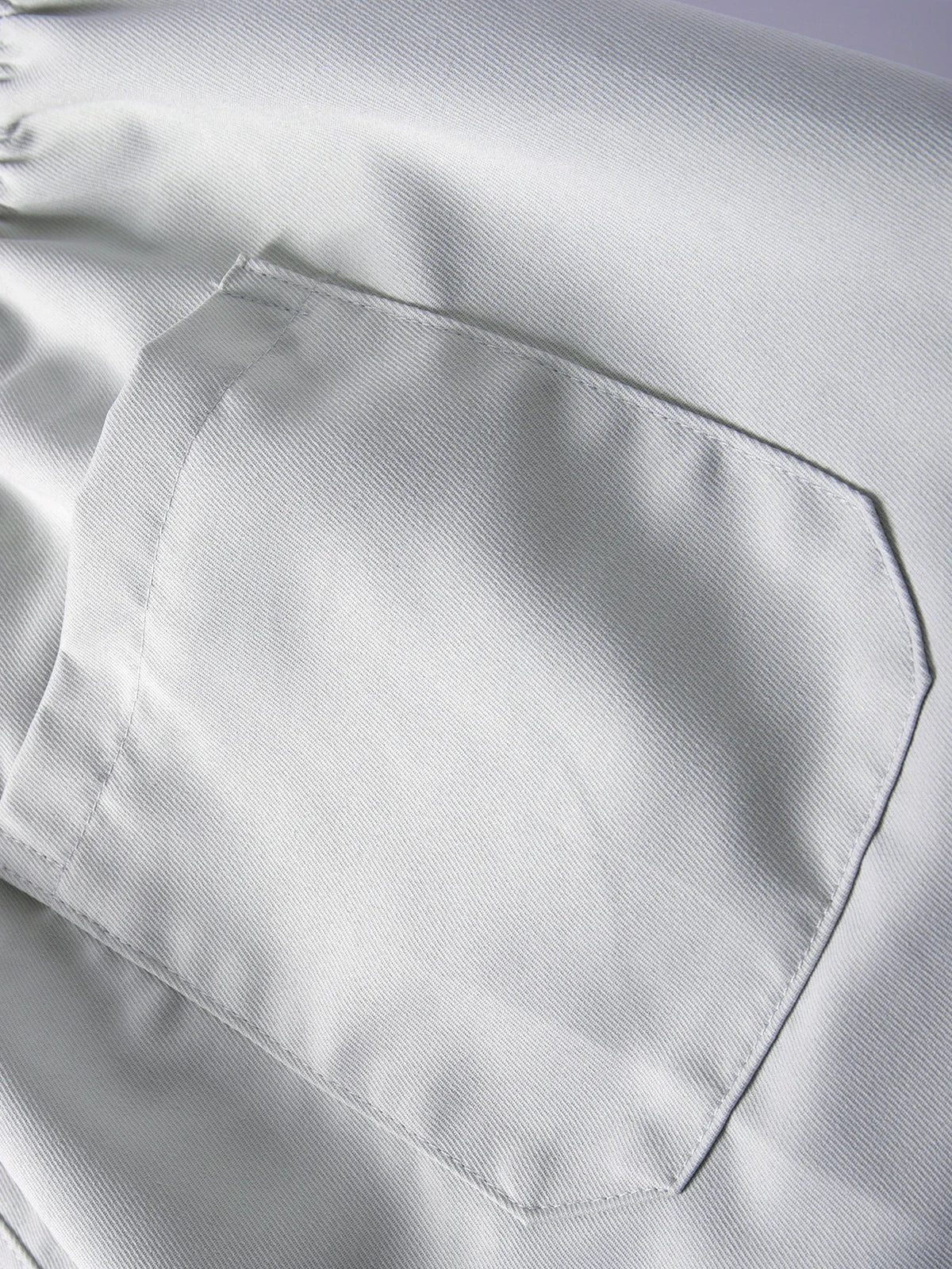 A close-up view of a white men's cargo jogger featuring a patch pocket on the side.