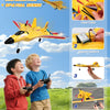A boy is launching a yellow foam SU-27 airplane using a remote control in an outdoor field.