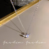 Silver crystal bow angel wings heart pendant necklace displayed on a light background.