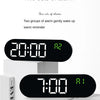 Two sets of alarm digital clocks showing 20:00 and 7:00 on white surfaces