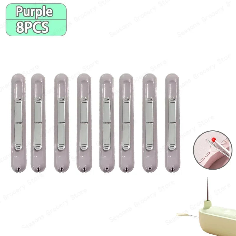 A set of eight purple needle threaders and seam rippers for sewing projects.