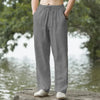 A person is wearing gray men's cotton linen casual jogger pants outdoors.