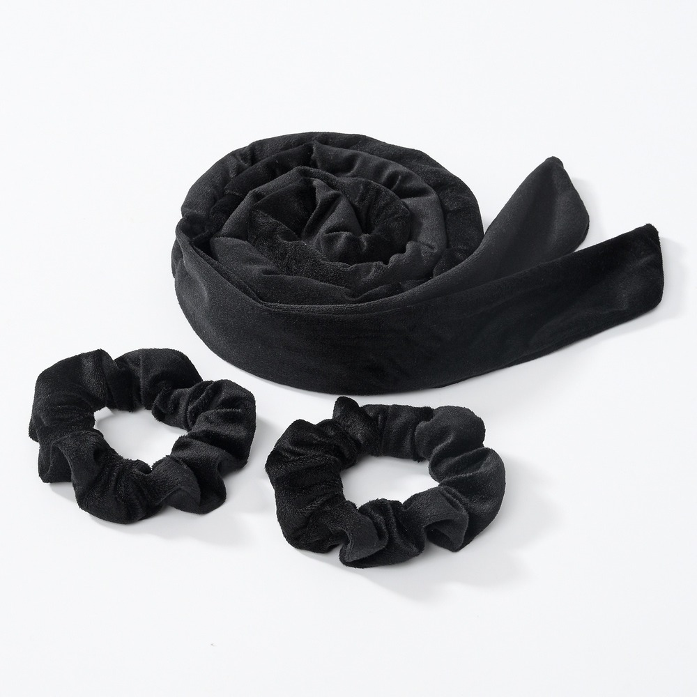 Black heatless curling rod headband rolled up and two separate bands shown on a white background