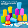 A colorful stacking cups game for kids with various colored cups and challenge cards laid out on a blue surface.