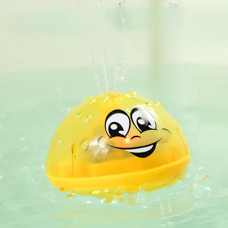 A yellow interactive bath toy with a smiling face is being sprayed by water in a clear container.