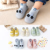 A collection of soft sole baby animal socks and shoes in various colors and designs for first walkers.