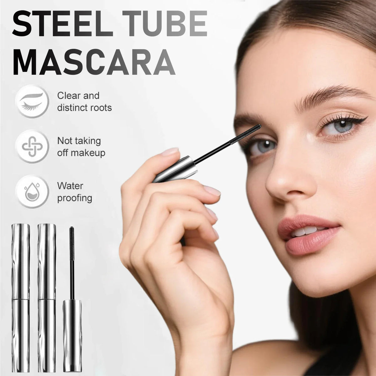 A woman applies steel tube mascara to her eyelashes using a defining brush.