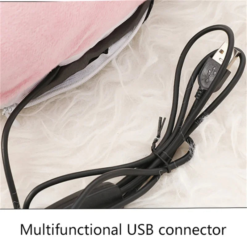 A black multifunctional USB connector cable lying on a light-colored surface next to a pink fleece cover.