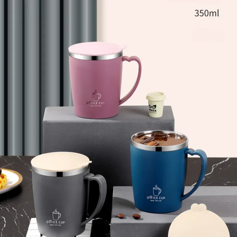 A pink and blue stainless steel insulated travel mug is shown on a gray surface.