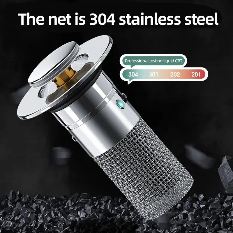 A silver press-type sink drain stopper with a stainless steel net filter is shown against a dark background.