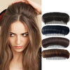 A close-up of a woman's hair showing various shades of brown and black hair extensions with invisible root lifter combs.