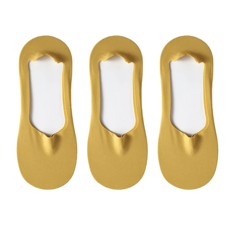 Three pairs of gold silicone grip no-show socks displayed against a white background.