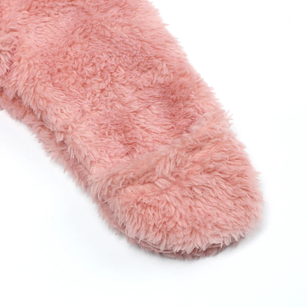 A close-up of a pink fuzzy baby fleece hooded romper with a zipper.