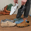 A collection of men's casual shoes including white leather loafers, black suede loafers, and tan lace-up loafers displayed on