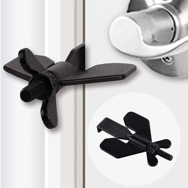 A black portable travel door lock with a secure latch is shown next to a white door frame.