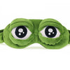 A soft green frog-themed sleep mask with large, round eyes.